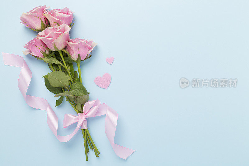 粉红色玫瑰与心的颜色背景，俯视图。情人节概念
