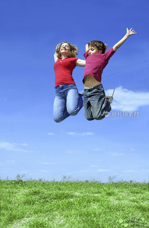 女孩和孩子在草地上跳跃