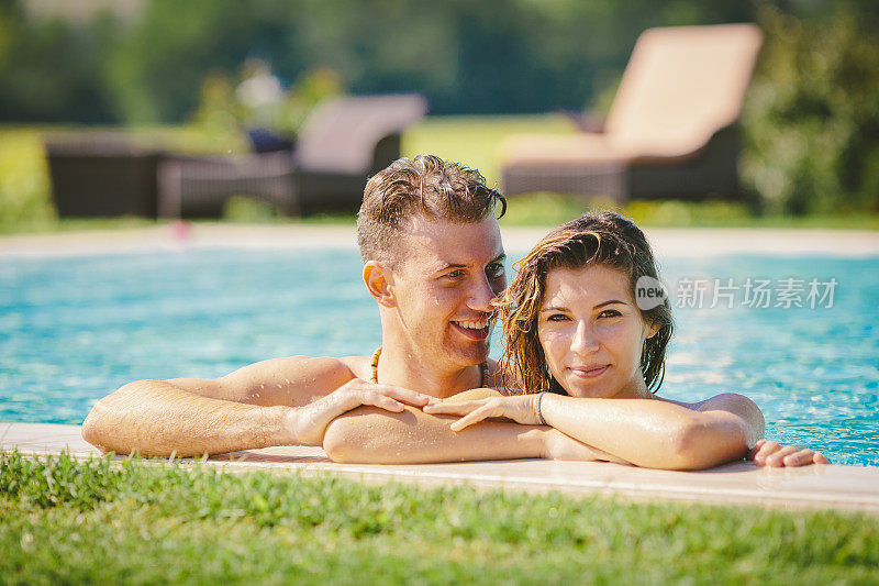 年轻夫妇在游泳池里