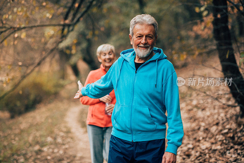 一对老年夫妇在公园里互相跟随