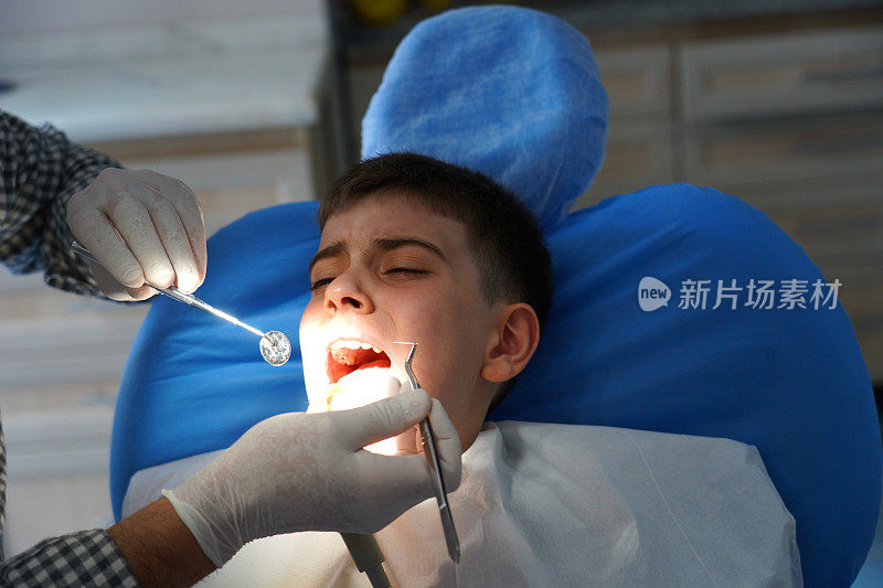 一个男孩正在做牙科手术，他很害怕