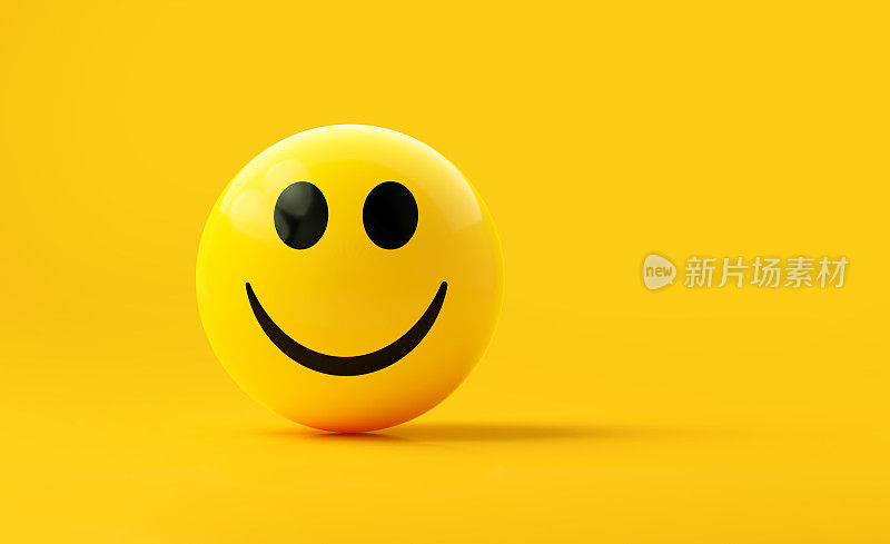 黄色球体纹理与快乐的脸表情符号在黄色背景