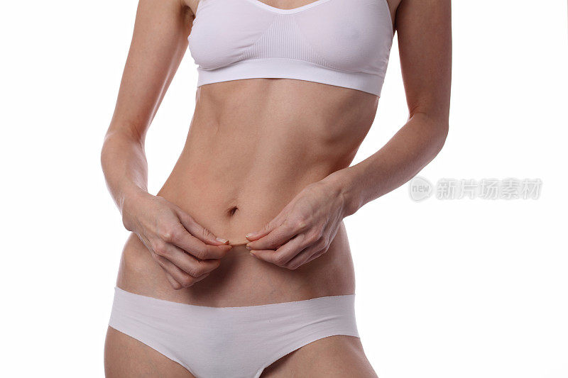 测量体脂百分比的女性。完美苗条的身体，腰部近。运动，健身，节食结果。