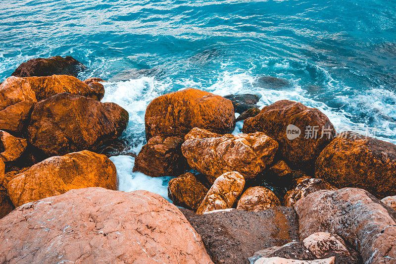 海边有一些橙色的岩石