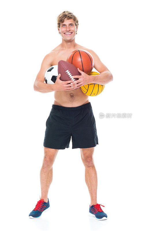 迷人的赤膊男子在运动服装持有运动球