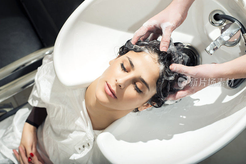 一位年轻女子在美容院洗头