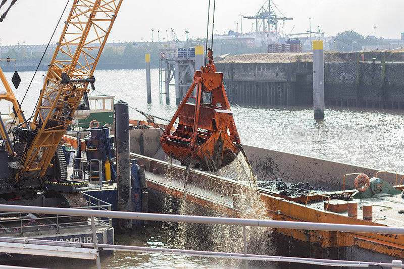 挖掘机正在挖掘德国汉堡港河床内的沉积物