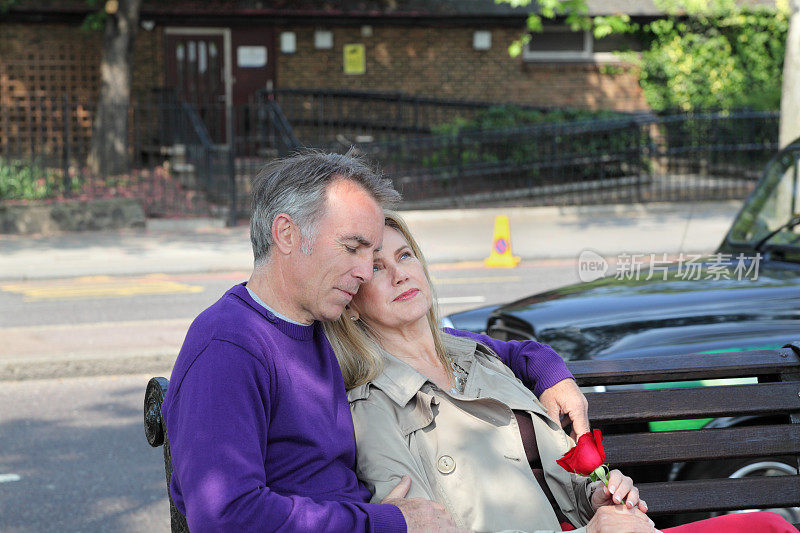 退休的成熟的白种夫妇放松在长凳上快乐的伦敦