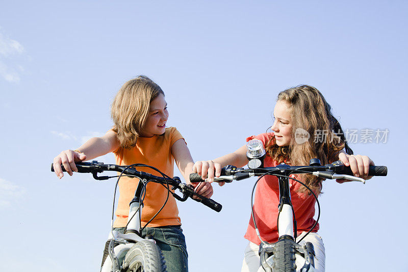 两个女孩骑着自行车
