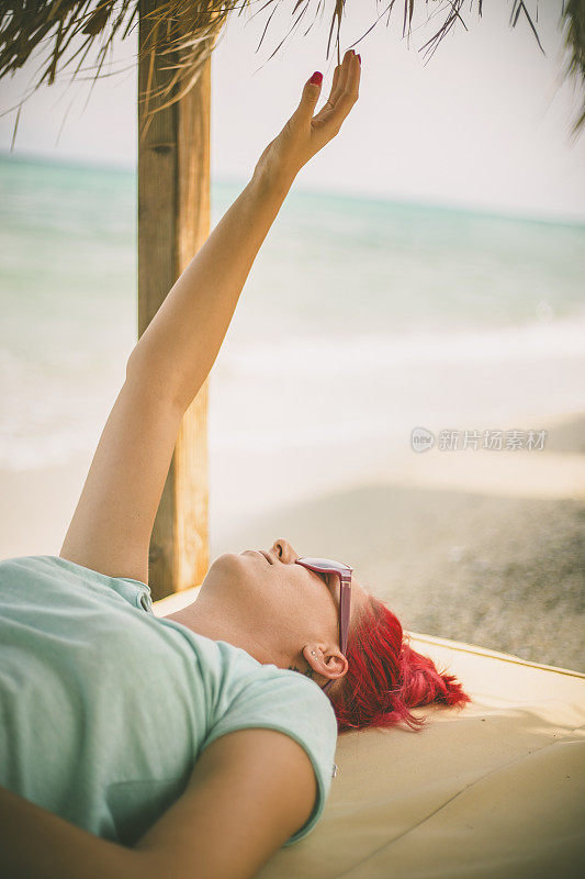 穿着夏装的女人望着天空和大海