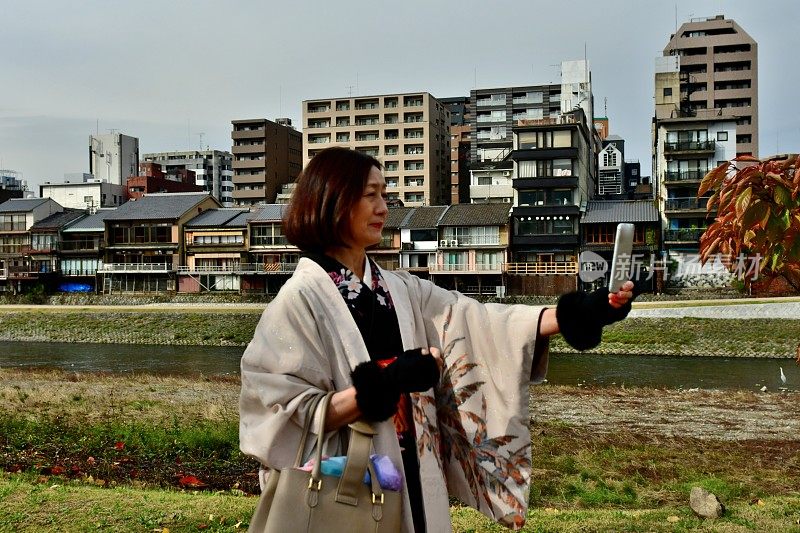 穿着和服的日本妇女在京都加茂河岸自拍