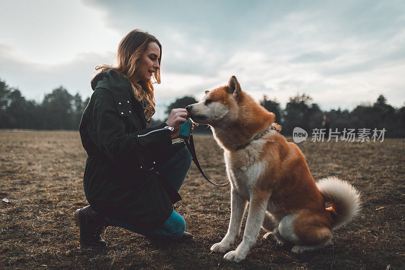 一个女人和她的宠物狗在公园里享受时光