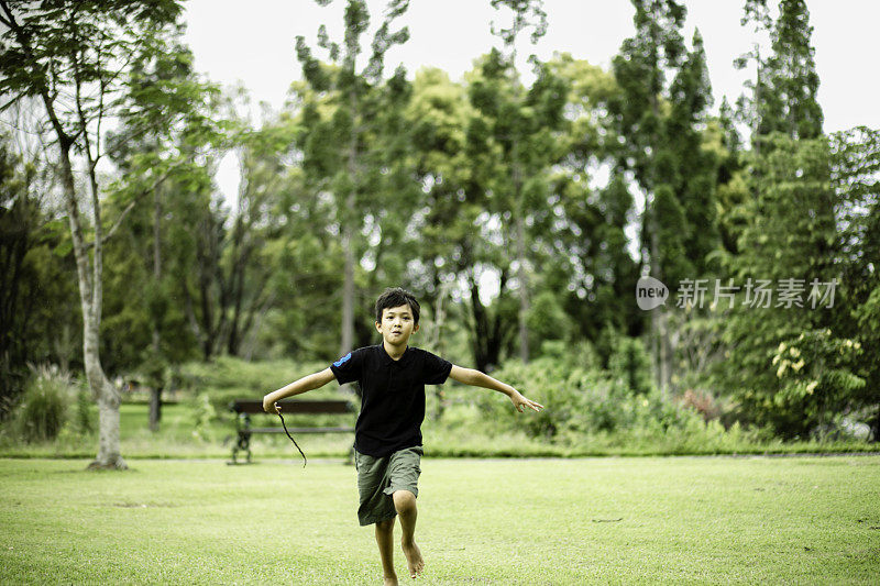 可爱的小男孩在公园里快乐地奔跑