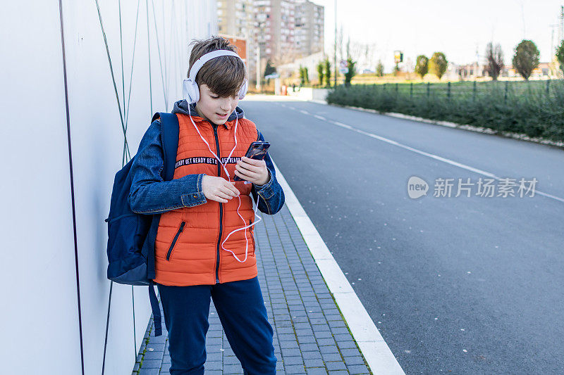 一个戴耳机的男生放学后要回家。