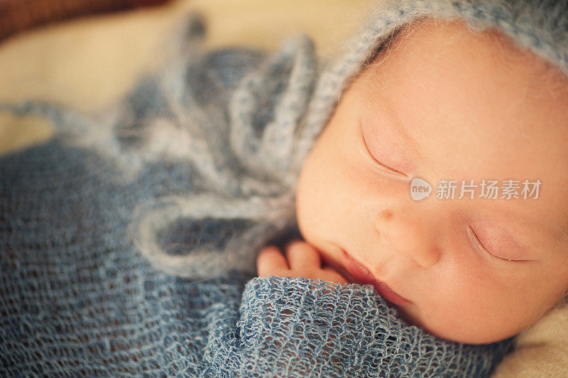 新生儿裹在毯子里睡觉