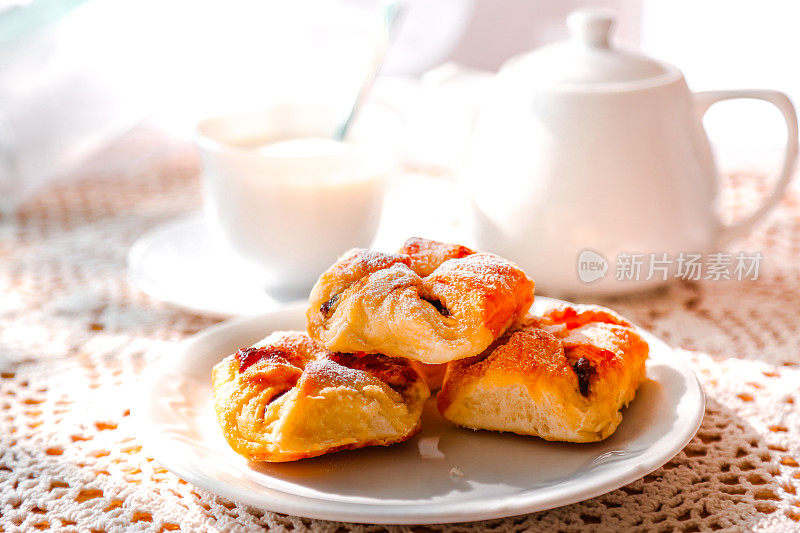 新鲜烘焙的丹麦糕点，白盘和热饮