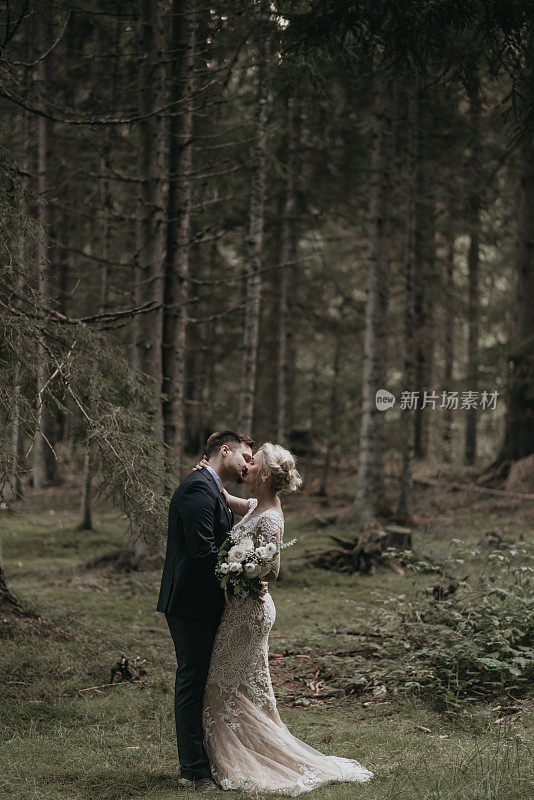 非常美丽的新娘和新郎正在享受浪漫时光，风在森林里吹着麦穗。