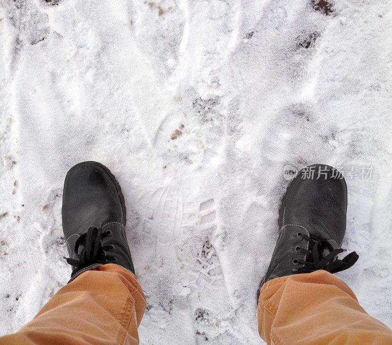脚踩在雪地里。