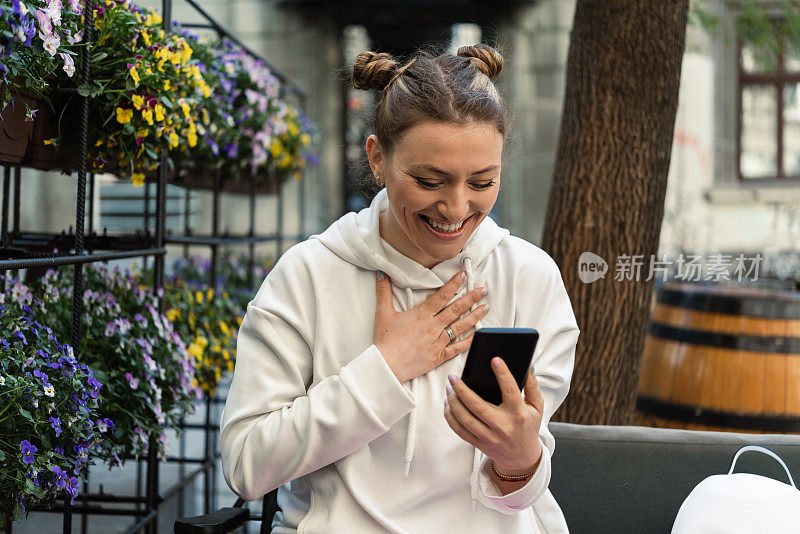 一个漂亮女人的肖像在网上与某人在咖啡馆聊天