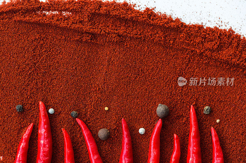 红辣椒，流行的香料概念-特写红辣椒豆荚装饰图案的棕色背景，由胡椒粉，圆形黑胡椒和杜松浆果，平铺