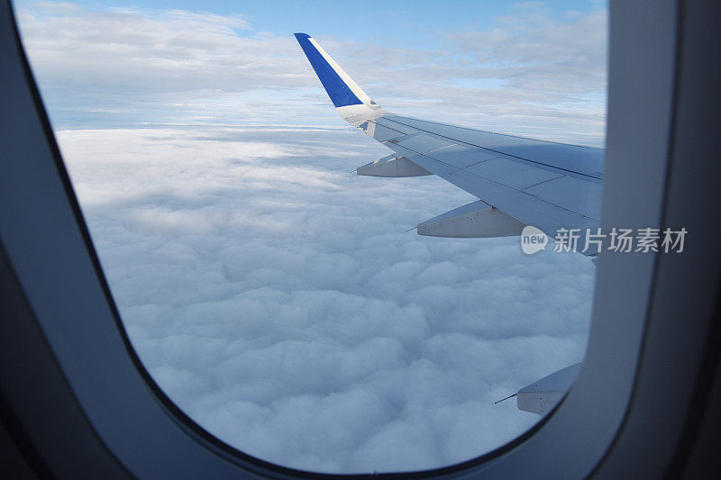 飞机乘客在一个机翼上与白天的天空。