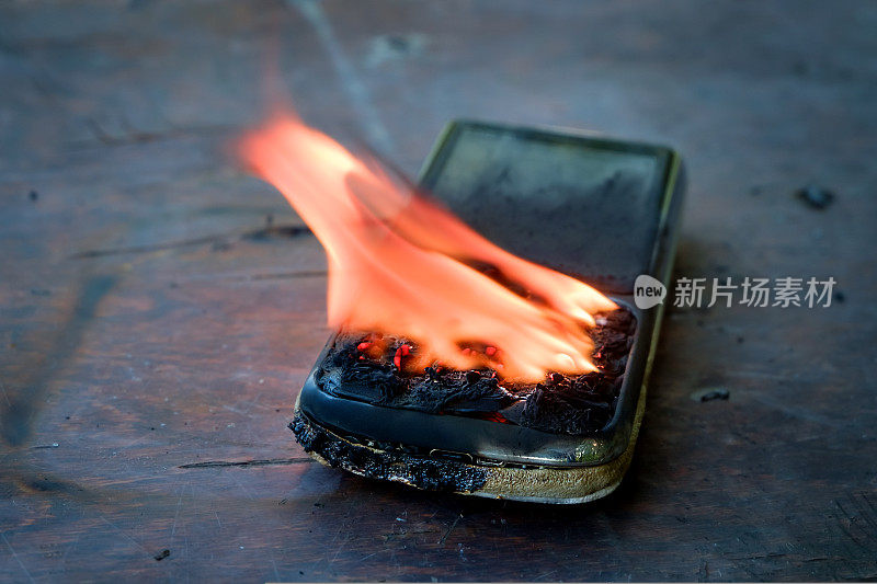 手机躺在桌子上，燃烧着明亮的火焰