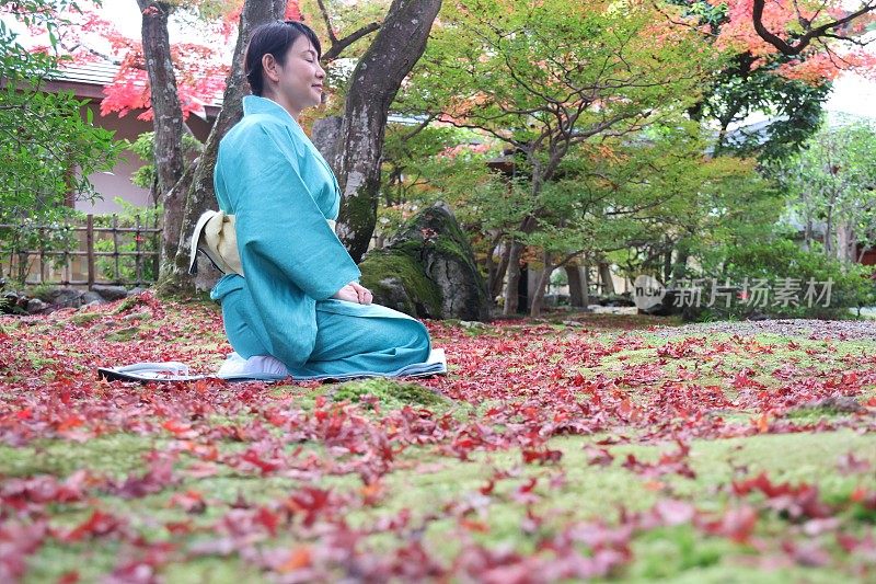 日本女子在传统的日本旅社花园冥想