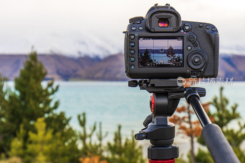相机设备在三脚架设置拍摄戏剧性的山景照片