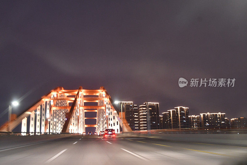 夜间高速公路上快速驶向大桥