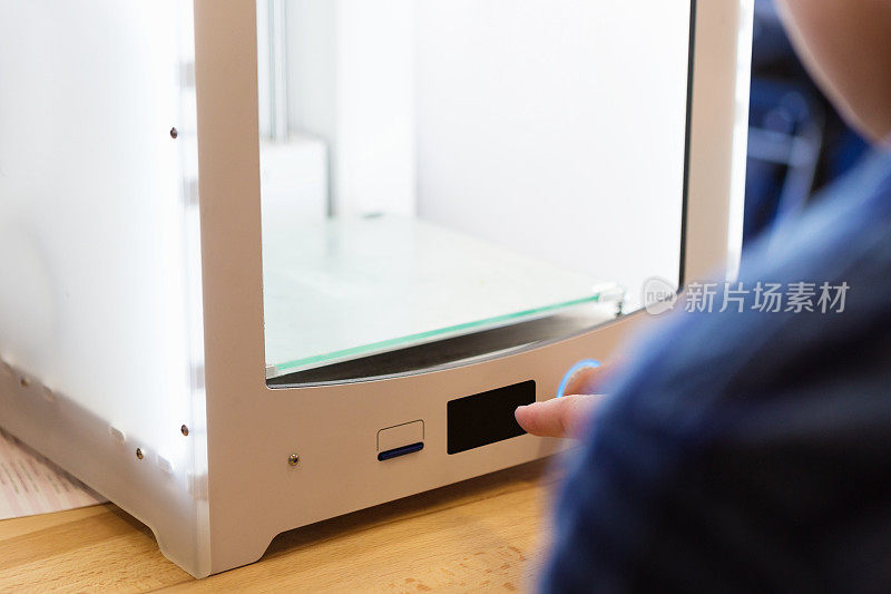 儿童使用触摸屏幕上的3D打印机在图书馆