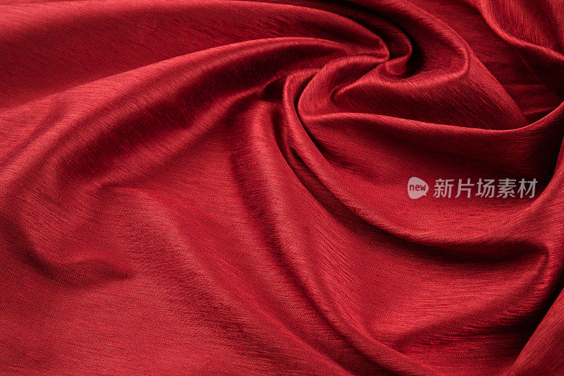 红色背景的豪华布料或波浪褶皱的垃圾丝绸纹理缎天鹅绒