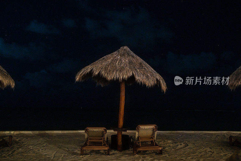 墨西哥坎昆-夜晚俯瞰大海的游泳池椅子