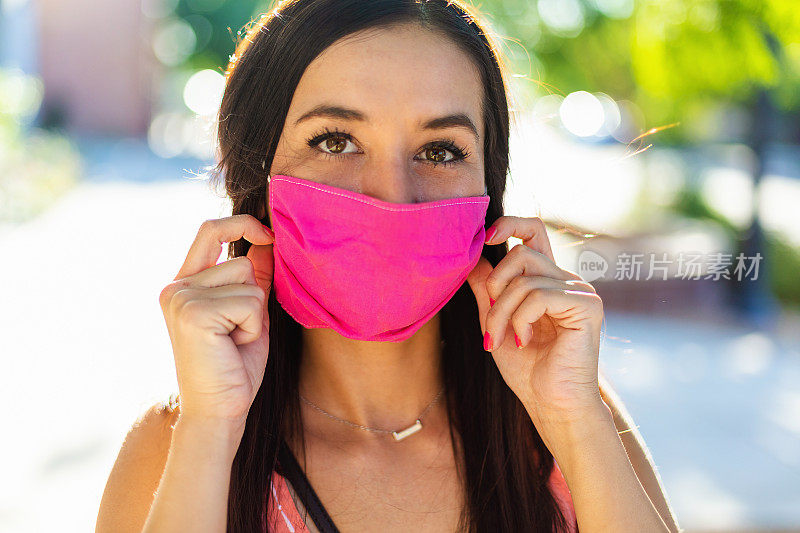 一位千禧女性在城市街道上戴口罩