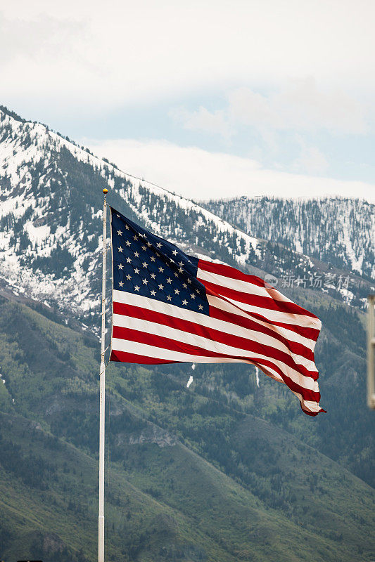 美国国旗在背后的群山中飘扬