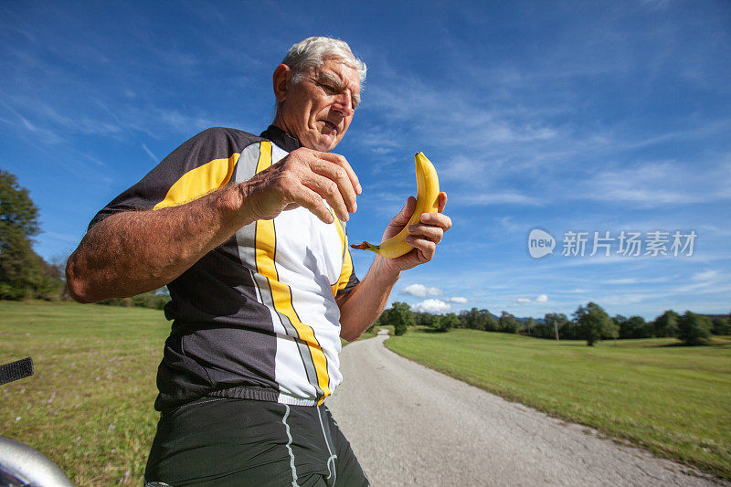 骑自行车的老人休息吃香蕉