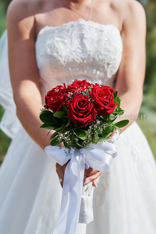 新娘手捧一束红玫瑰