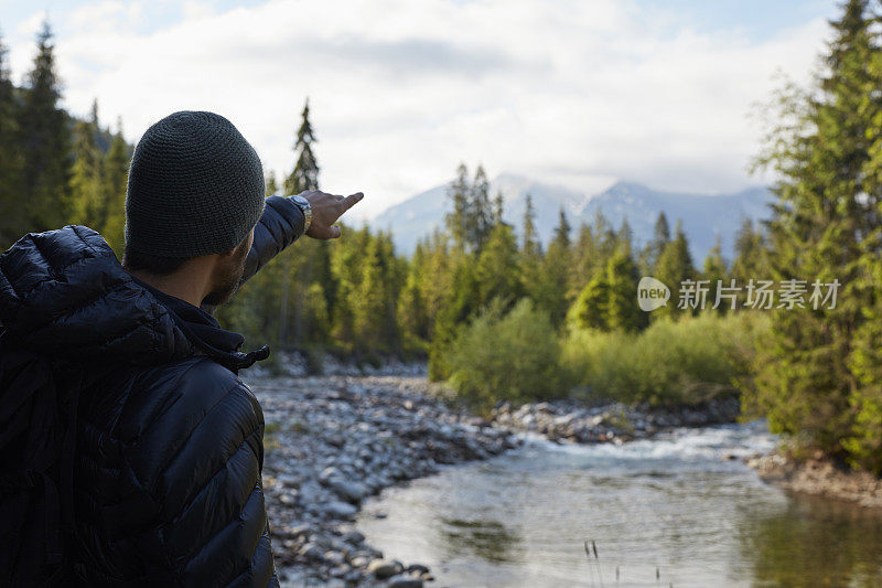 一对夫妇在山里徒步旅行。指着他们要去的地方