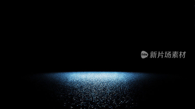 闪亮的蓝色闪光在舞台地板上被一个明亮的聚光灯照亮在一个黑色的背景