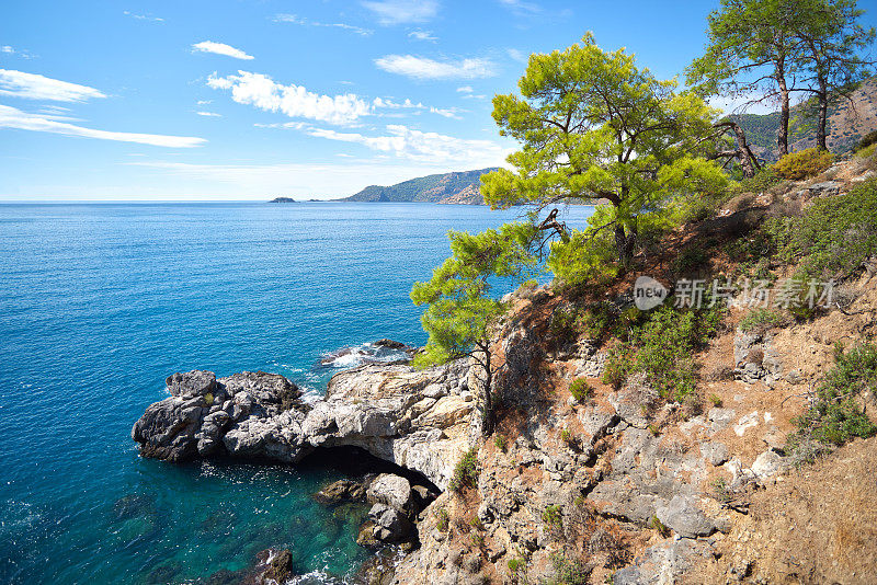 从山上眺望蔚蓝的地中海和松树、山坡岩石