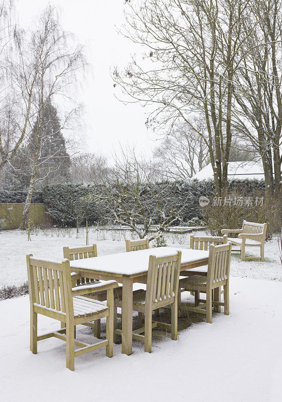 英国，冬天，雪花落在庭院家具上