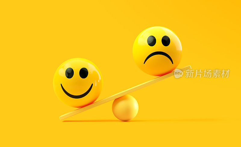黄色背景上的黄色跷跷板上有快乐和悲伤表情符号的黄色球体