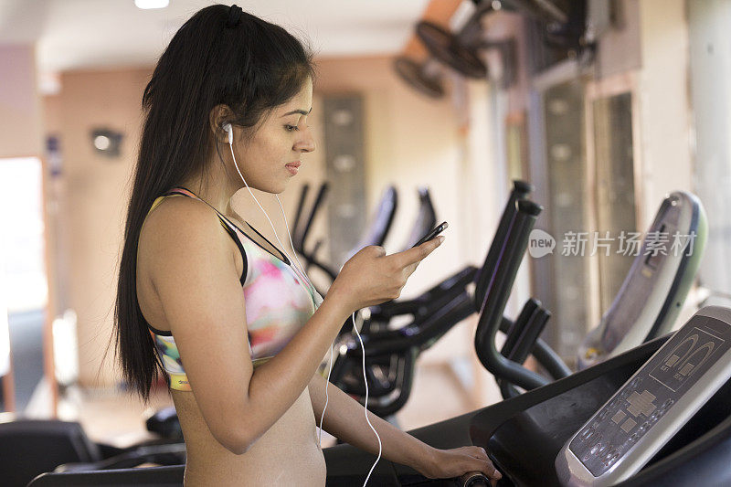 健身房里跑步机上的健康女性