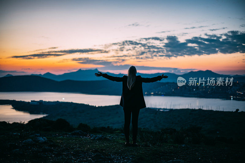 美丽的金发女人在夜晚的城市风景