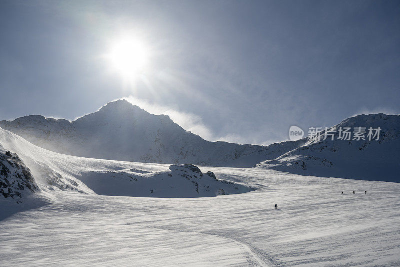 滑雪登山运动员攀登白雪皑皑的山峰