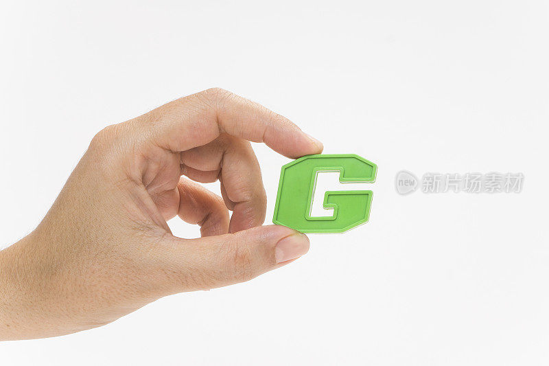 女性手握塑料字母G