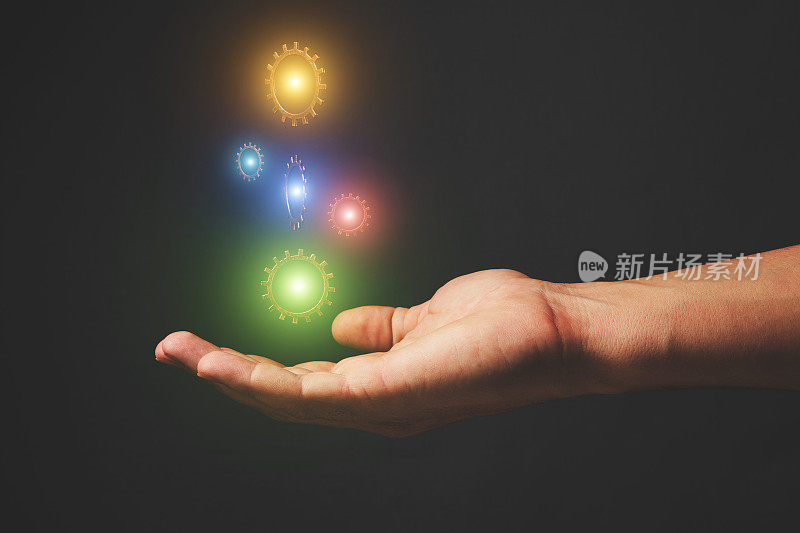 手握悬浮齿轮发光不同的颜色。发展理念，魔术与科技。