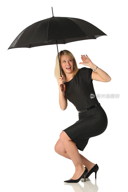 孤立的女商人躲在伞下