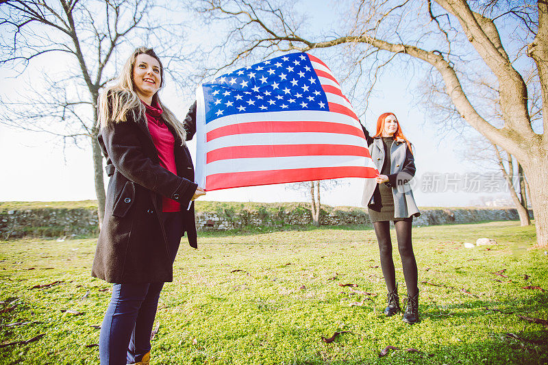 两个女孩举着美国国旗