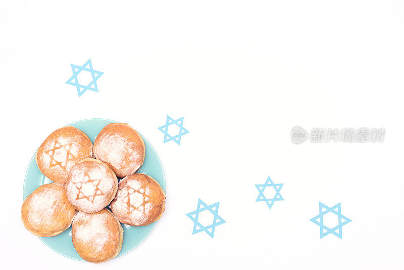 光明节场景与传统的光明节甜甜圈sufganiyot和蓝色的大卫星星在白色的背景。平铺风格与复制空间