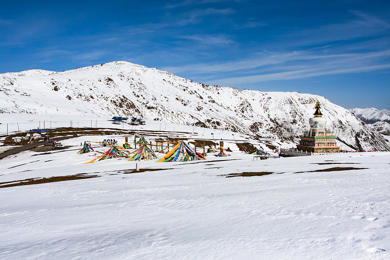 中国青海，在青藏高原上，一种藏族宗教活动在雪山顶上进行，雪山顶上，白塔，藏传佛教